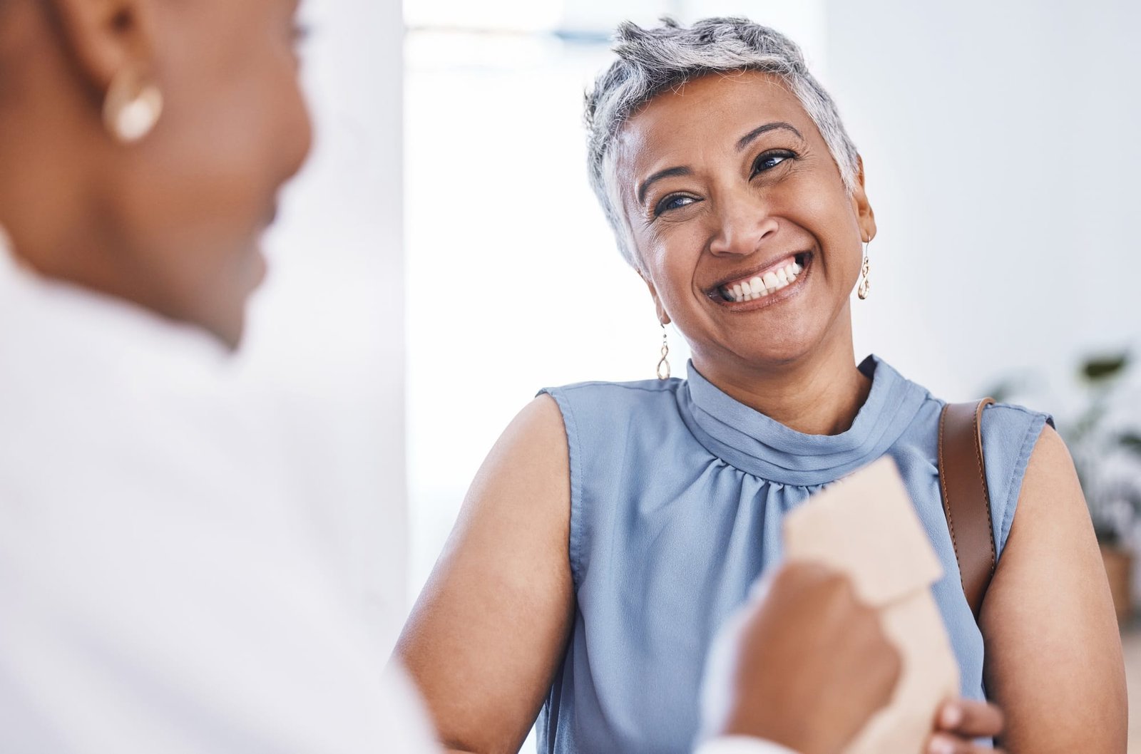 Happy, medical and a woman customer in a pharmacy for medicine, talking to a professional consultan