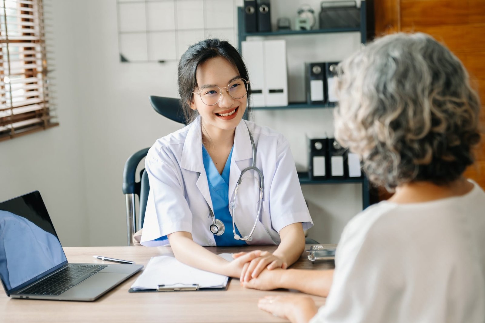 The doctor holds the patient’s. hand Healthcare and medical concept.